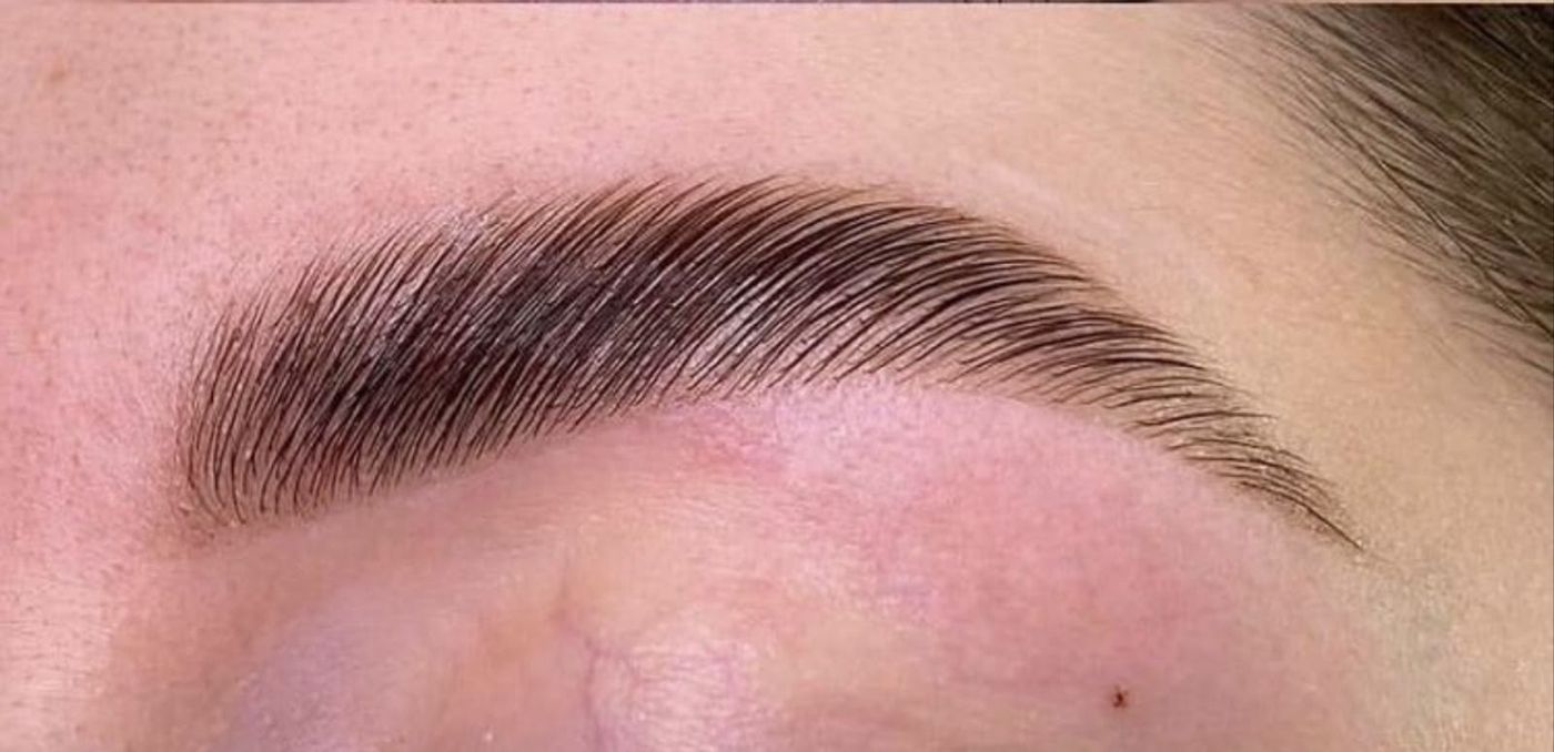 A full, brushed-up brow after lamination at Edge Eyebrows Threading